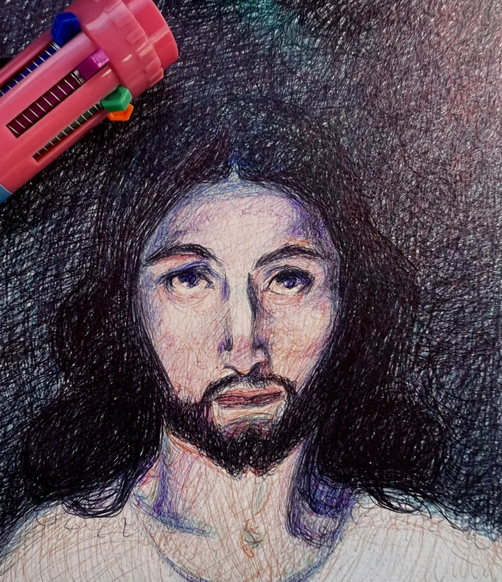 Multicolor ballpoint drawing of Christ with long dark hair and a beard against a dark ground, a pen lying at the corner.