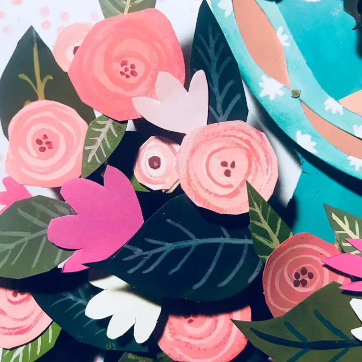 Layered painted paper cut-outs of pink roses, pink tulips, and dark navy leaves, shown close up against teal.