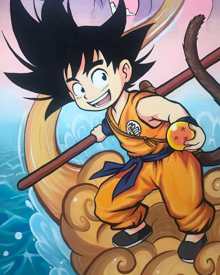 Painting of young Goku with his staff, holding an orange star ball and riding a golden cloud over blue waves.