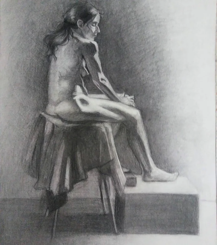 Charcoal life drawing of a nude woman seated on a draped stool, seen in profile.