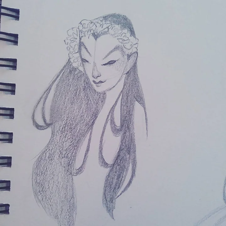 Pencil sketch of a woman with downcast eyes, a floral headpiece, and long flowing hair on a spiral sketchbook page.